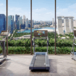 Luxury gym overlooking Marina Bay skyline at One Marina Gardens, a leading example of Singapore's green condos blending city living with nature